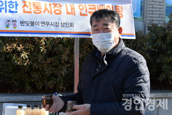 서광석 연무시장 상인회장이 판매 상품을 들고 포즈를 취하고 있다. [사진=이민희 기자]