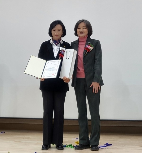 정윤경 경기도의회 부의장(왼쪽)이 8일 군포중학교 제41회 졸업식 및 체육관 개관식에서 감사패를 받고 있다. [사진=경기도의회]